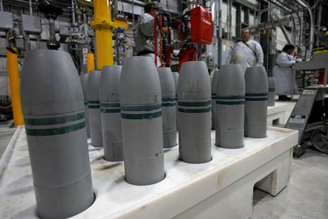 A palette of grey missiles in an industrial unit